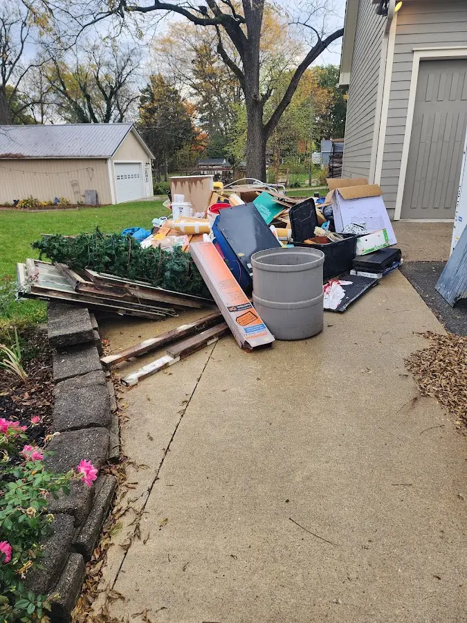 Dumpster being loaded with debris for Estate Cleanout Dumpster Rental in Kingsville